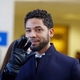 Actor Jussie Smollett waves as he follows his attorney to the microphones after his court appearance on March 26, 2019 in Chicago, Illinois.